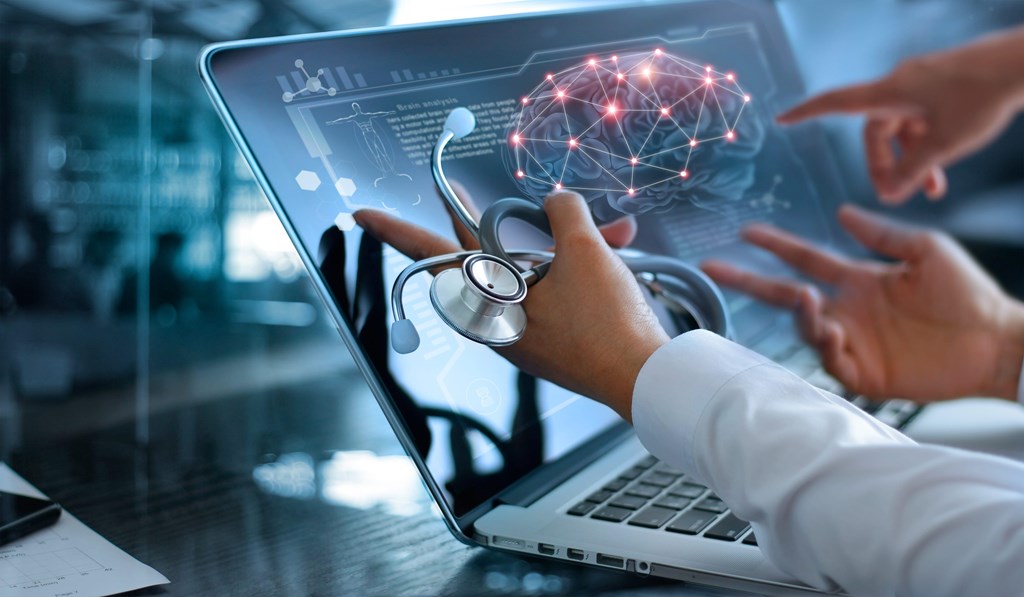 Medical professional holding a stethoscope beside a laptop with digital technology overlay